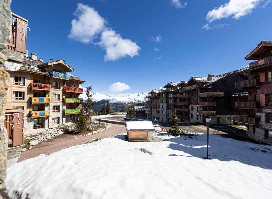 Discover the charm of mountain living in this stunning property, featuring a picturesque view of snow-capped mountains and charming architecture.