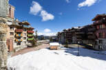 Discover the charm of mountain living in this stunning property, featuring a picturesque view of snow-capped mountains and charming architecture.