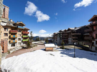 Discover the charm of mountain living in this stunning property, featuring a picturesque view of snow-capped mountains and charming architecture.