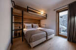 Discover the charm of this cozy bedroom featuring a unique bunk bed design, perfect for families or groups.