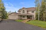 This stunning property boasts a beautiful exterior with a combination of stone and siding, creating a warm and inviting curb appeal.