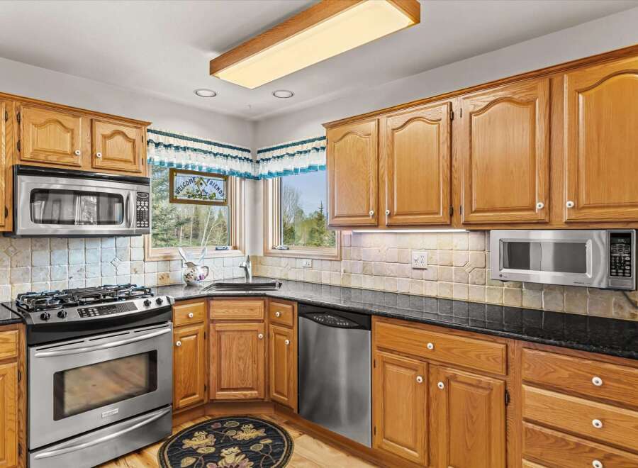 This stunning kitchen boasts beautiful wooden cabinetry, offering ample storage and a warm, inviting atmosphere.