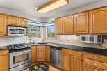 This stunning kitchen boasts beautiful wooden cabinetry, offering ample storage and a warm, inviting atmosphere.