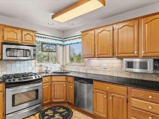 This stunning kitchen boasts beautiful wooden cabinetry, offering ample storage and a warm, inviting atmosphere.