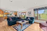 This stunning living space features a cozy seating area with a plush, navy blue sectional and armchair, perfect for relaxing.