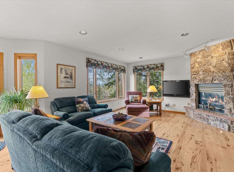 Step into this inviting living room, featuring a cozy fireplace and ample natural light.