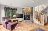 This cozy living room features a stunning stone fireplace, perfect for those chilly evenings.