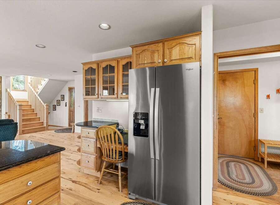 Step into this inviting kitchen, featuring a modern stainless steel refrigerator and ample wooden cabinetry.