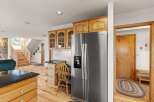 Step into this inviting kitchen, featuring a modern stainless steel refrigerator and ample wooden cabinetry.