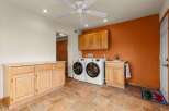 This laundry room boasts a functional design with ample storage and modern appliances.
