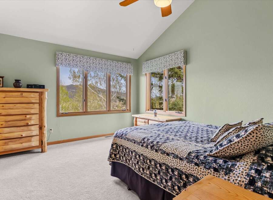 This charming bedroom offers a serene retreat with its rustic wooden furniture and inviting ambiance.