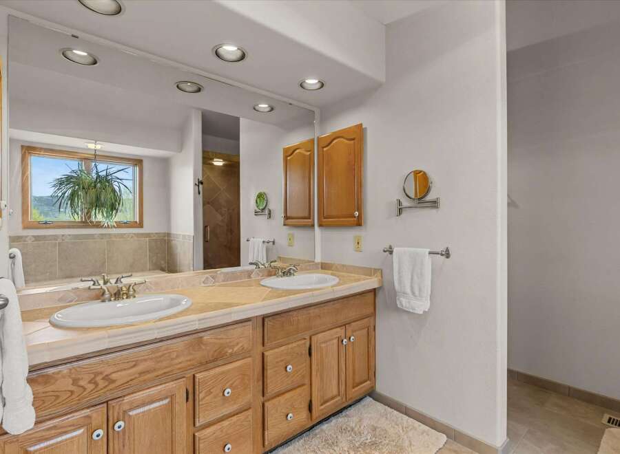 This beautiful bathroom features a double vanity with ample storage, perfect for a shared space.