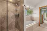 Step into luxury with this stunning bathroom featuring a spacious walk-in shower and a relaxing jacuzzi tub.