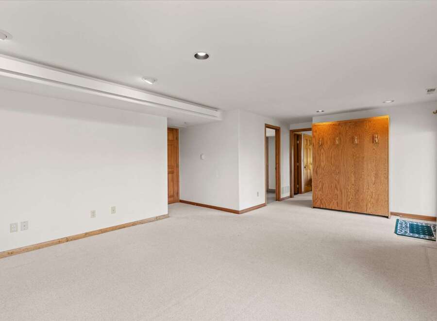 This spacious room features a neutral color palette, creating a versatile space for various design styles.