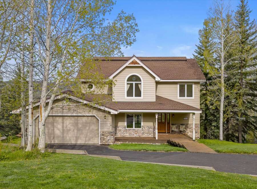 This stunning property boasts a beautiful exterior with a combination of stone and siding, creating a charming curb appeal.