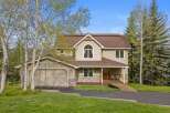 This stunning property boasts a beautiful exterior with a combination of stone and siding, creating a charming curb appeal.