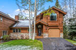 This stunning property boasts a beautiful wooden exterior and a charming stone facade, creating a warm and inviting atmosphere.