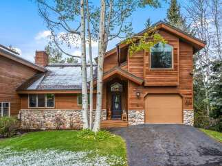 This stunning property boasts a beautiful wooden exterior and a charming stone facade, creating a warm and inviting atmosphere.