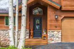 This stunning property boasts a charming exterior with a beautiful wooden facade and a welcoming entrance.