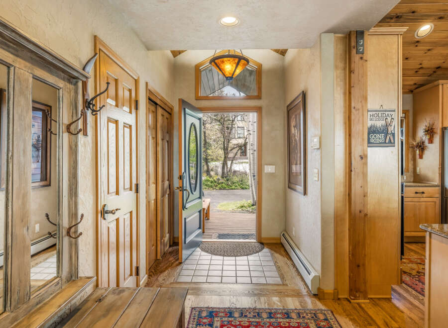 Step into this inviting entryway, showcasing a blend of rustic charm and modern comfort.