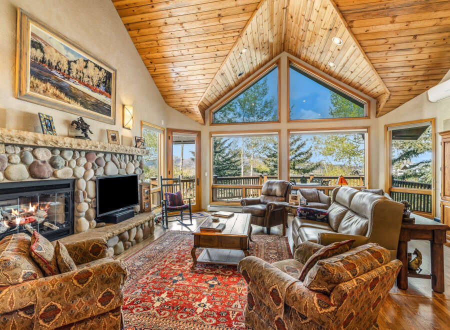 Step into luxury with this stunning living room, featuring a cozy fireplace and a spacious layout.