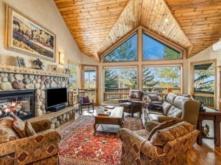 Step into luxury with this stunning living room, featuring a cozy fireplace and a spacious layout.