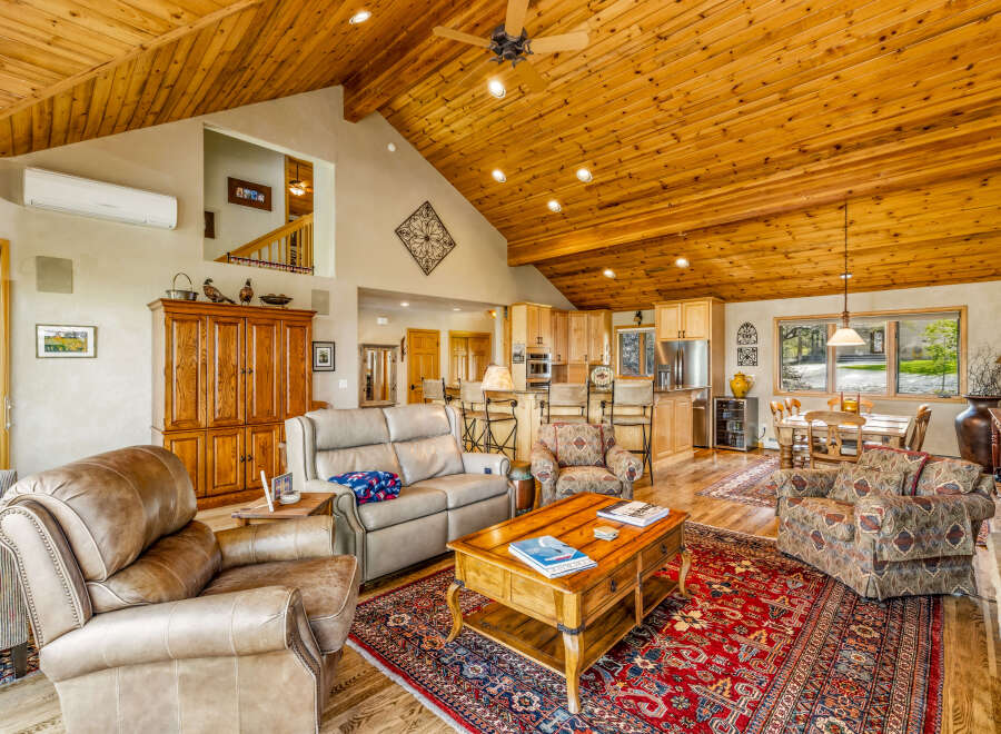 Step into luxury with this stunning property featuring a spacious living area with a vaulted wooden ceiling.