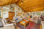 Step into luxury with this stunning property featuring a spacious living area with a vaulted wooden ceiling.