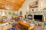 This stunning property boasts a cozy living room with a stone fireplace, perfect for relaxing evenings.
