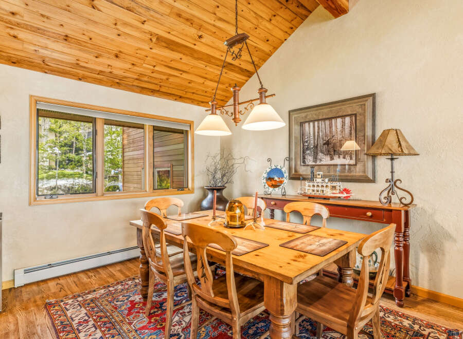This charming dining room features a rustic wooden table and chairs, perfect for family gatherings.