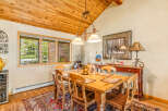 This charming dining room features a rustic wooden table and chairs, perfect for family gatherings.