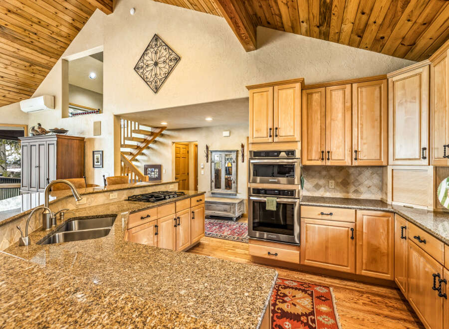 This stunning kitchen boasts a warm and inviting atmosphere, perfect for culinary enthusiasts.