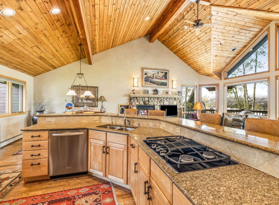 This stunning kitchen boasts a warm and inviting atmosphere with its wooden ceiling and cabinetry.