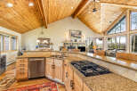 This stunning kitchen boasts a warm and inviting atmosphere with its wooden ceiling and cabinetry.