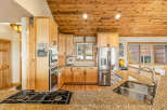 This stunning kitchen boasts a warm and inviting atmosphere with its natural wood cabinets and ceiling.