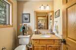 This charming bathroom features a warm, inviting ambiance with its wooden cabinetry and neutral color palette.