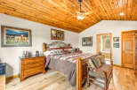 Step into this inviting bedroom, featuring a warm wooden ceiling and flooring that create a cozy atmosphere.