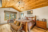 Step into a cozy bedroom retreat featuring a stunning wooden ceiling and warm, inviting ambiance.