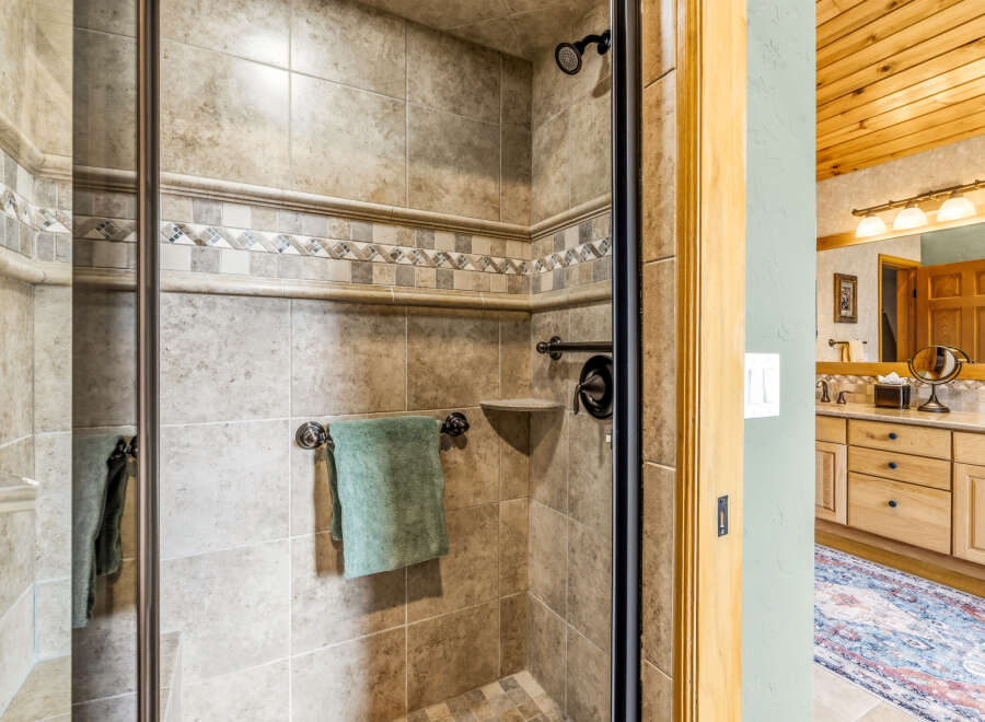 Step into luxury with this stunning bathroom, featuring a beautifully tiled shower and elegant fixtures.