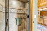 Step into luxury with this stunning bathroom, featuring a beautifully tiled shower and elegant fixtures.