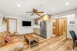 This inviting living space features a cozy leather sofa and a rustic wooden coffee table, perfect for relaxing.
