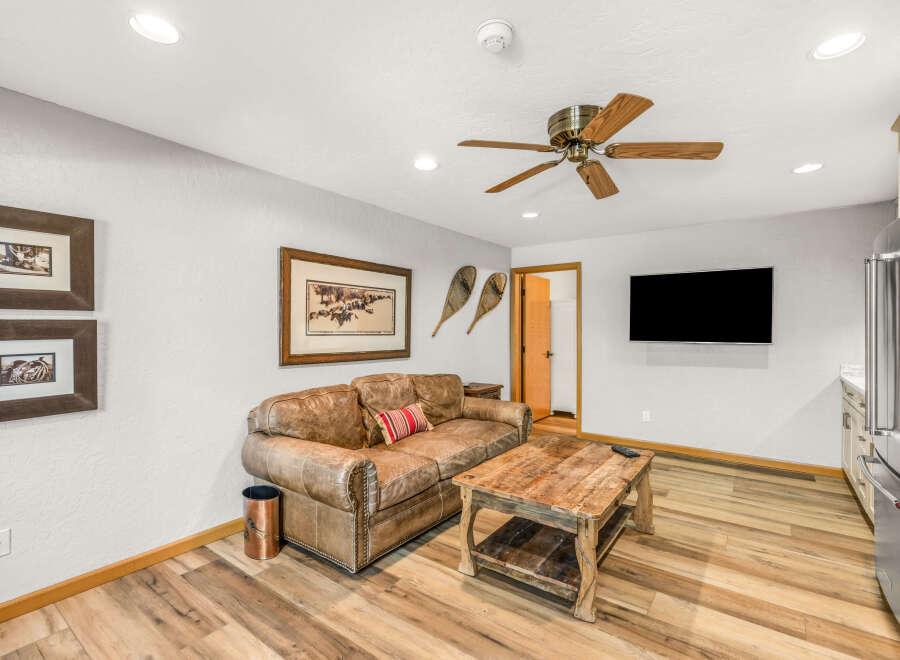 This inviting living space features a cozy leather sofa, perfect for relaxing after a long day.
