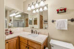 This charming bathroom features a stylish vanity with a marble countertop and a sleek, modern sink.