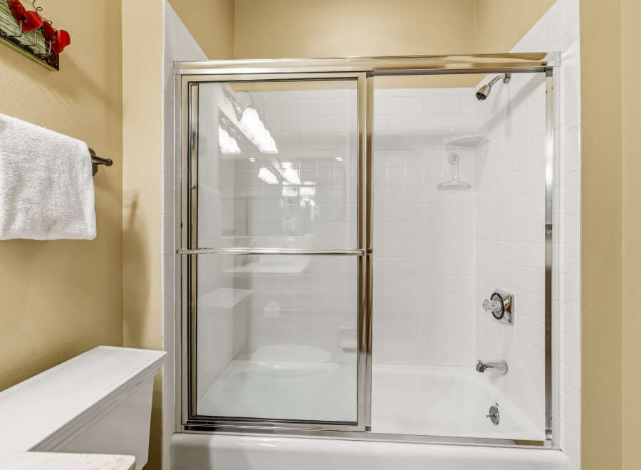Step into a pristine bathroom featuring a modern glass shower enclosure.