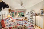 This charming bedroom features two cozy beds adorned with colorful quilts, perfect for a comfortable stay.