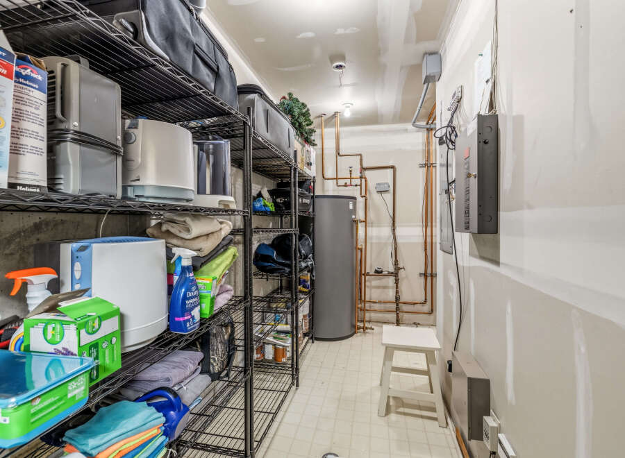 This utility room offers ample storage space with its multiple shelving units, perfect for organizing household items.