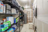 This utility room offers ample storage space with its multiple shelving units, perfect for organizing household items.