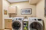 This laundry room features modern appliances and ample storage space, perfect for keeping your home organized.