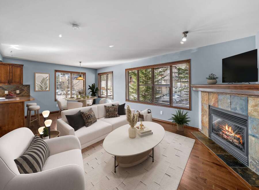 Step into luxury with this stunning living room, featuring a cozy fireplace and a sleek, modern design.