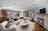 Step into luxury with this stunning living room, featuring a cozy fireplace and a sleek, modern design.